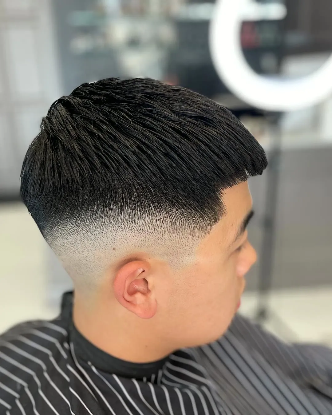 Textured fringe with a skin fade, side view
